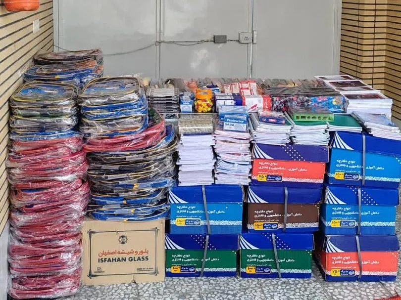 Cartons of notebooks and wrapped stacks of backpacks from the distributor